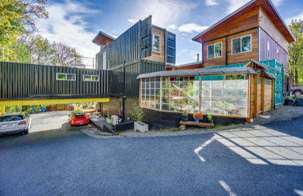 Modern house with green roof and glass walls in a residential area