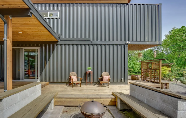 Modern house with metal siding and wooden deck area
