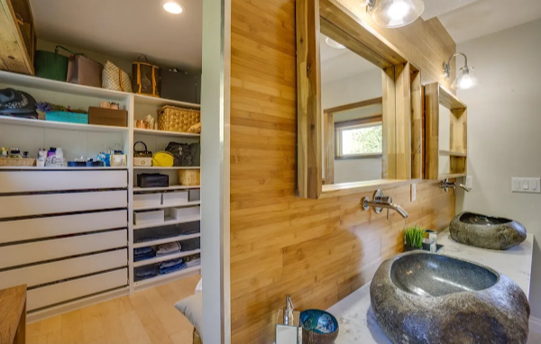 Bathroom with stone sinks and wooden walls