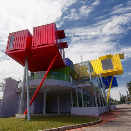 Colorful building with oversized container-like structures against a blue sky.