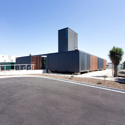Modular building made of shipping containers with a clear blue sky