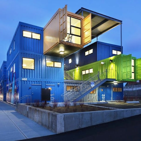 Container building with blue, green, and brown colors at dusk.