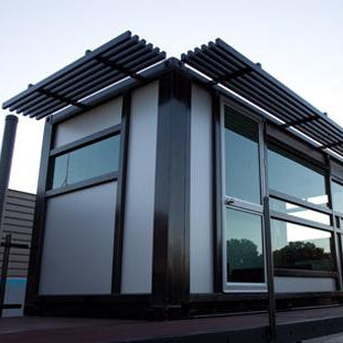 Modern building with glass facade and metal roof structure