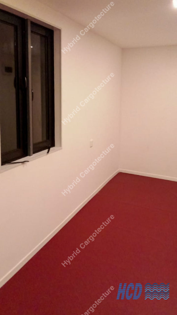 Empty room with red carpet and white walls