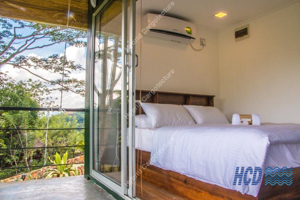 Furnished guest bedroom opening to nature at Sola Nature Resort